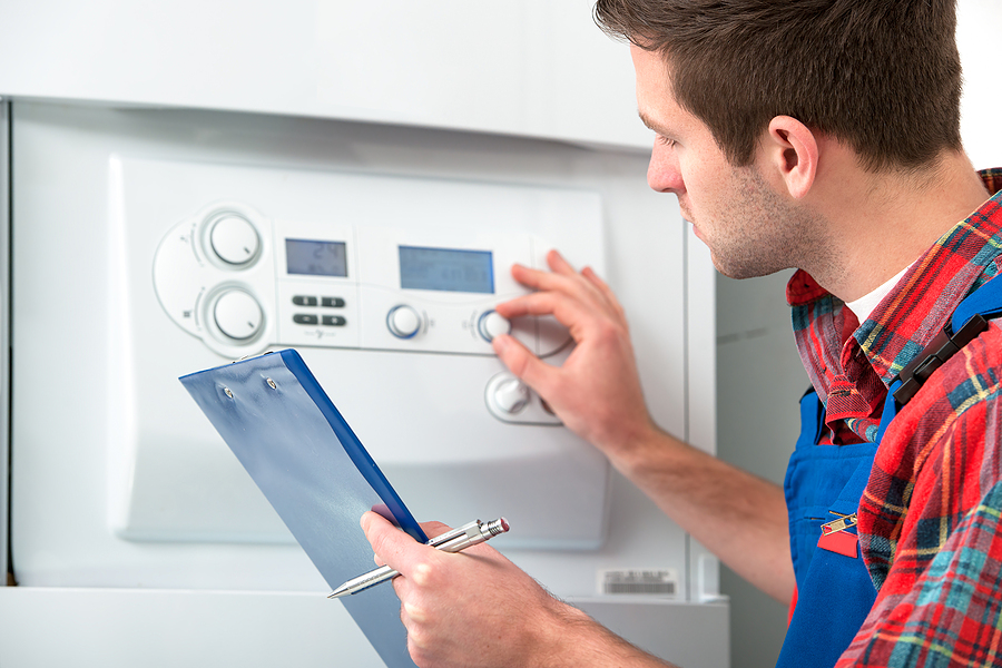 man checks the boiler