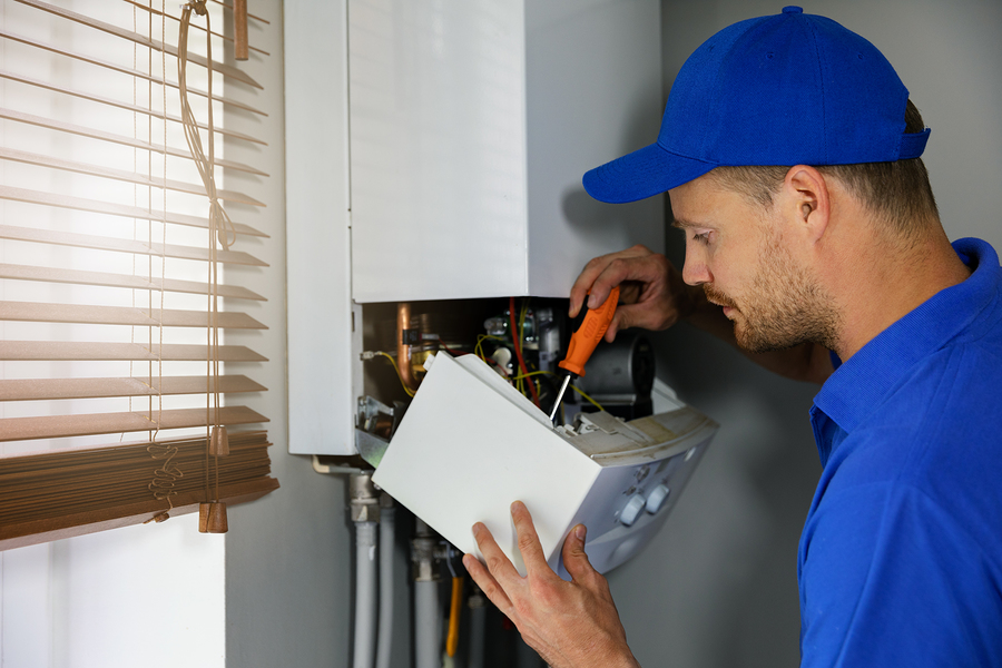 man repairing the boiler